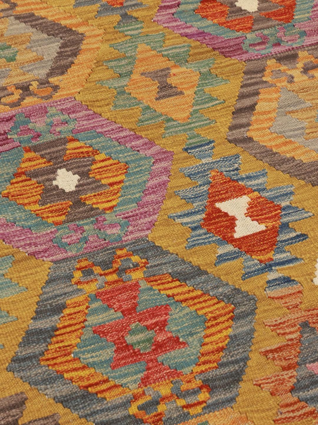 Hand-woven Kelim Afghan runner with geometric patterns in multicolor wool.