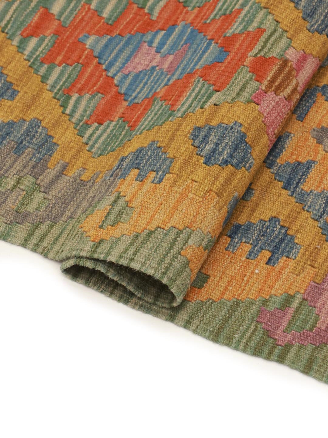 A hand-woven, multicolored Afghan runner rug with a diamond pattern