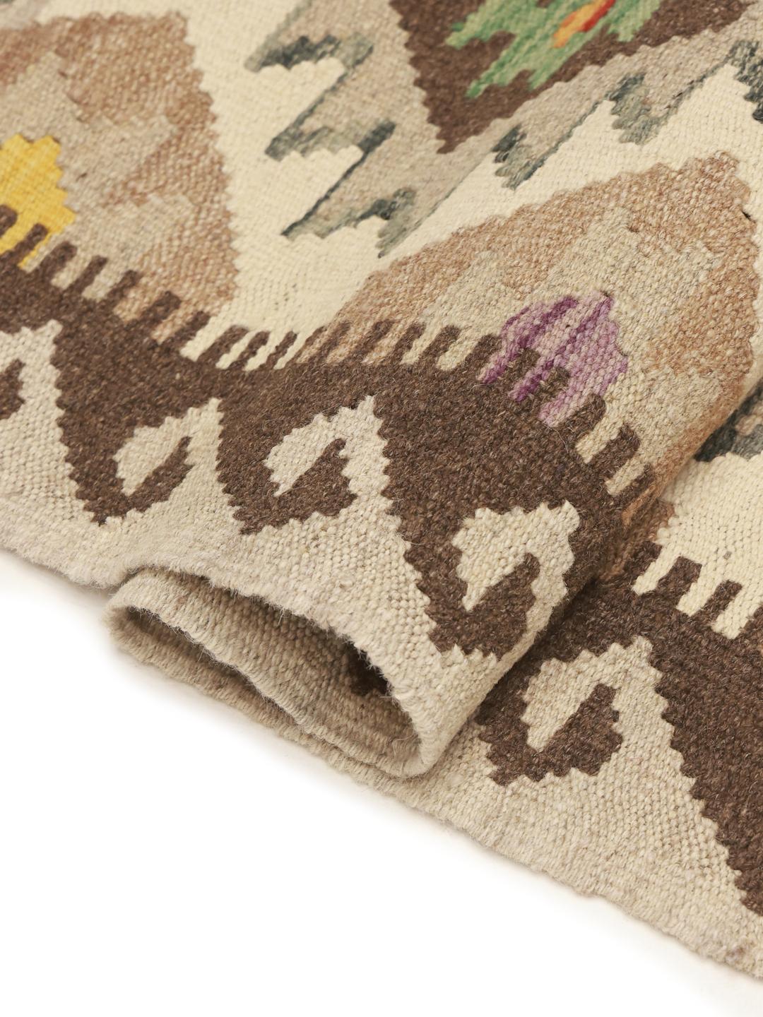 Hand-woven Afghan runner with geometric diamond patterns in beige and multicolor