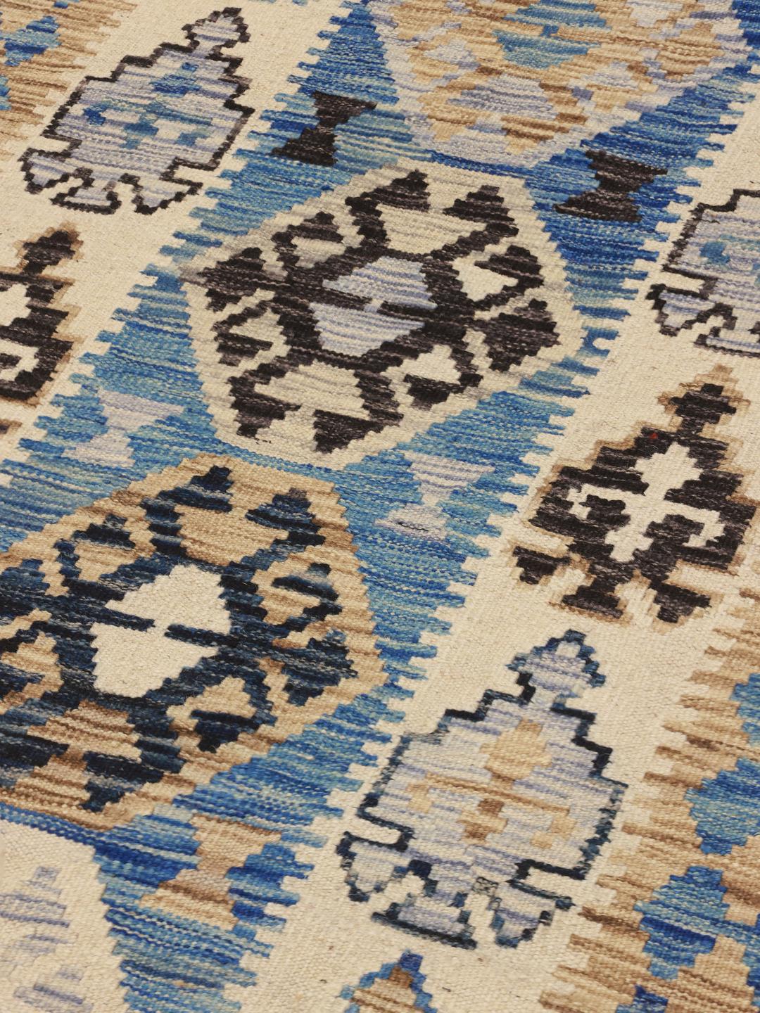 Hand-woven Afghan runner featuring blue and beige geometric patterns