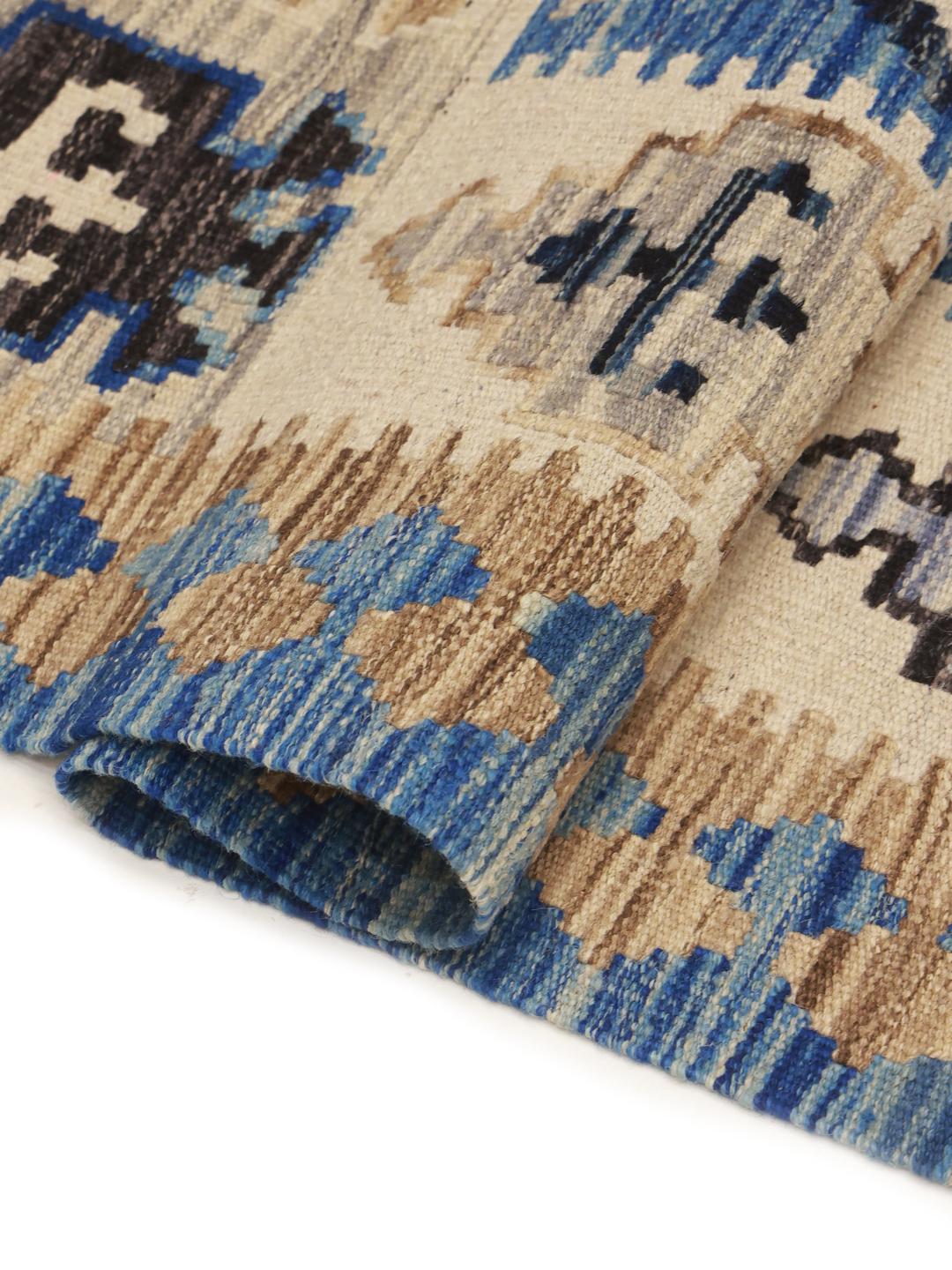 Hand-woven Afghan runner featuring blue and beige geometric patterns