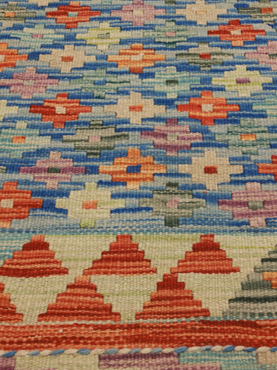 Hand-woven Afghan runner with blue and red geometric motifs