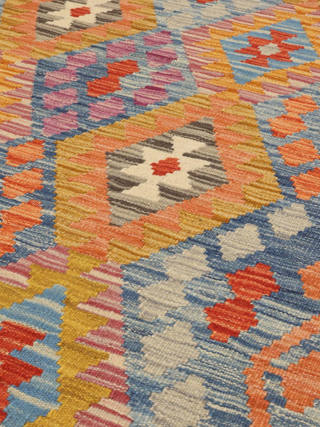 Hand-woven Afghan runner with vibrant geometric diamond patterns in a multicolor palette