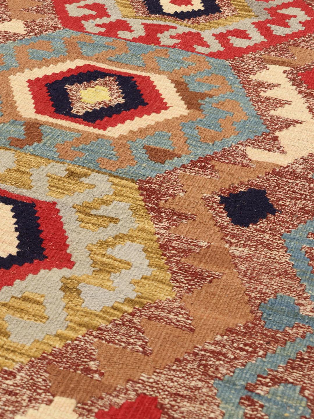 Hand-woven Afghan runner with traditional geometric patterns in multicolour