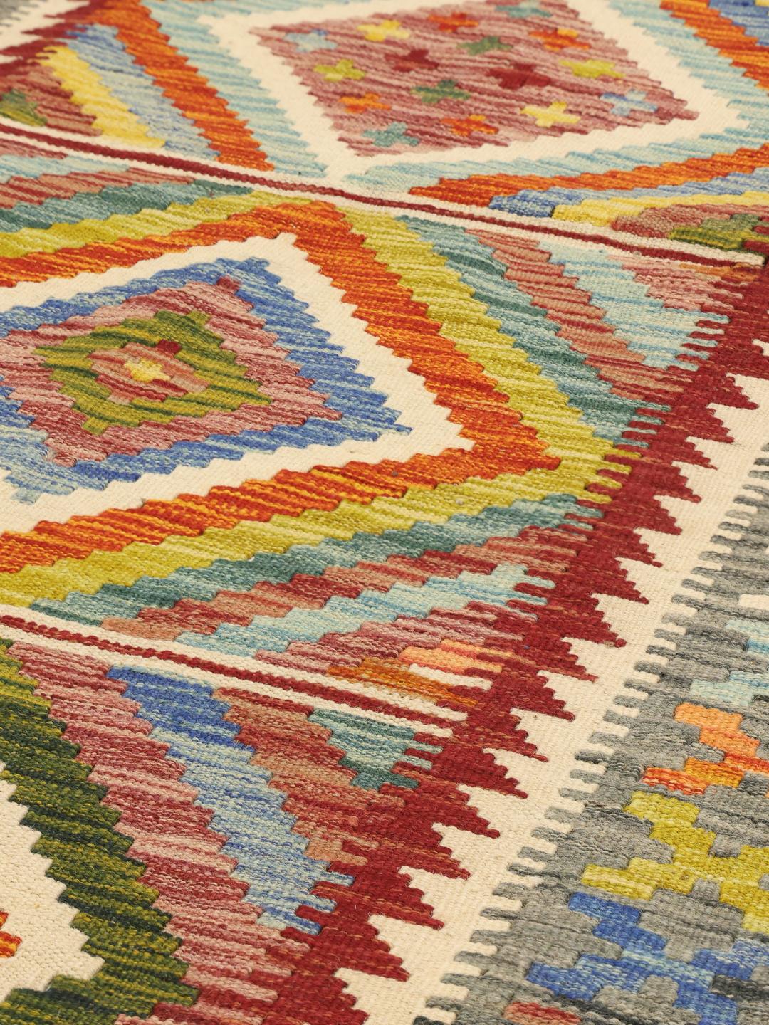 Hand-woven Afghan runner featuring a vibrant, multicolor geometric diamond pattern.