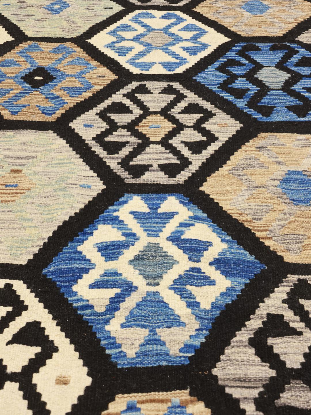 Hand-woven Afghan Kelim rug featuring blue and beige geometric patterns