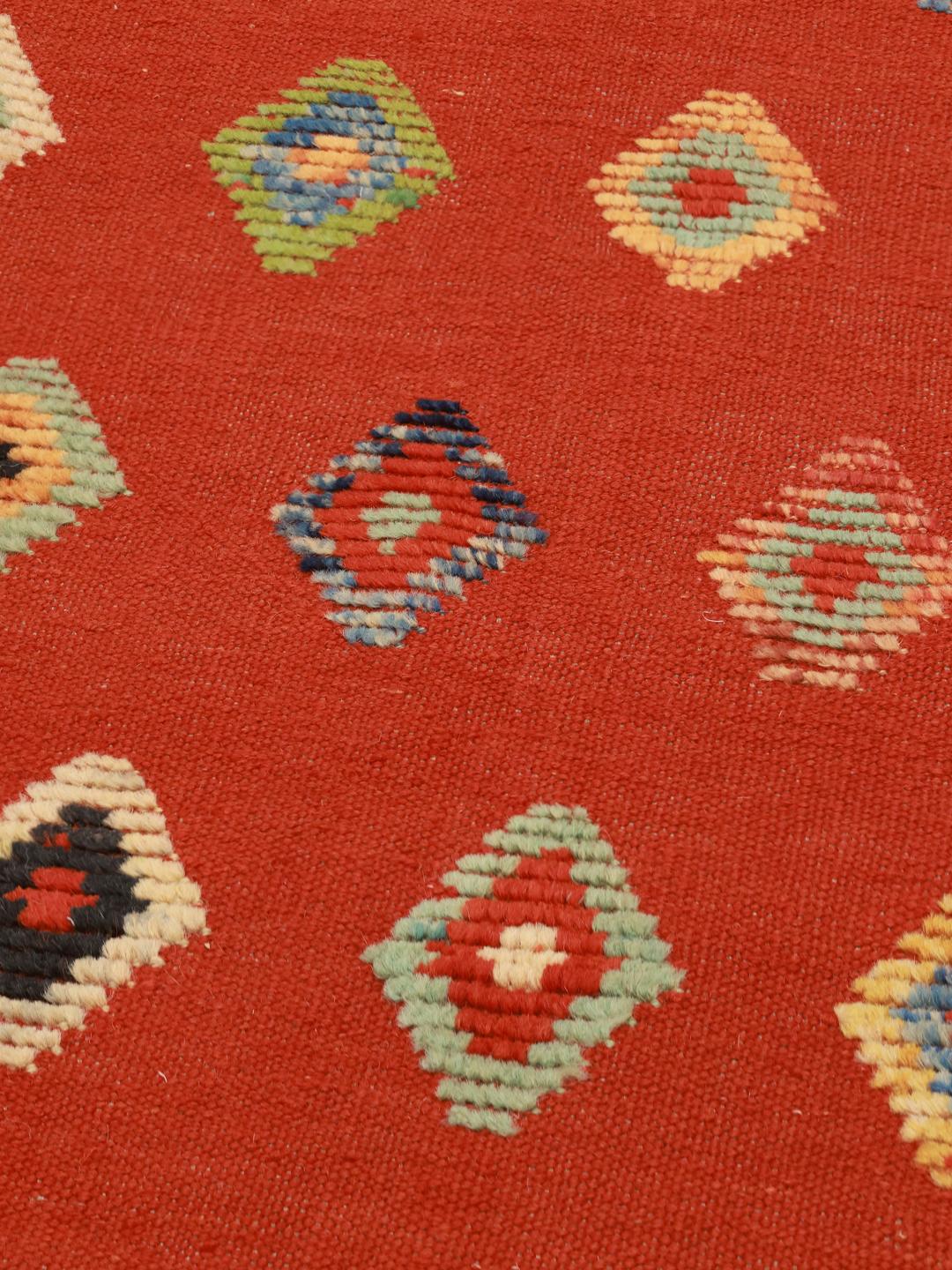 Hand-woven Afghan Kelim Nimbaft rug with a red field and multi-coloured geometric diamonds