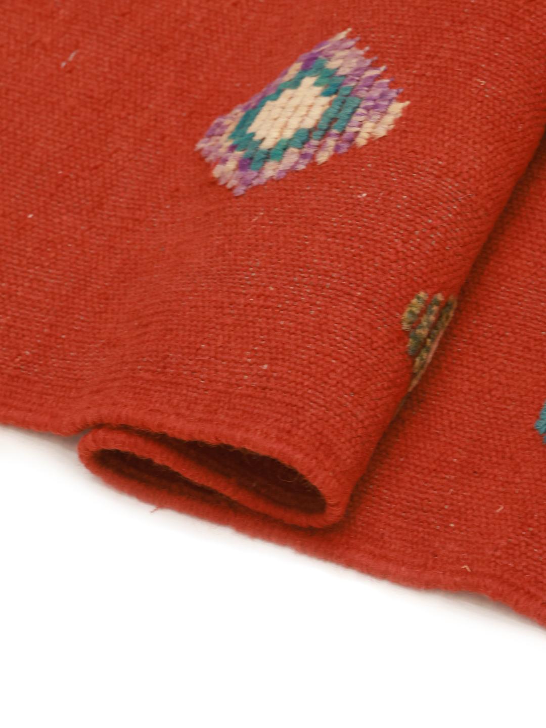 Hand-woven Afghan Kelim Nimbaft rug with a red field and multi-coloured geometric diamonds
