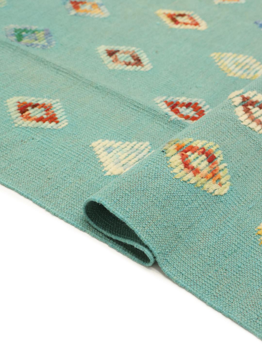 Hand-woven Afghan Kelim Nimbaft rug with a teal field and multicolour diamond patterns.