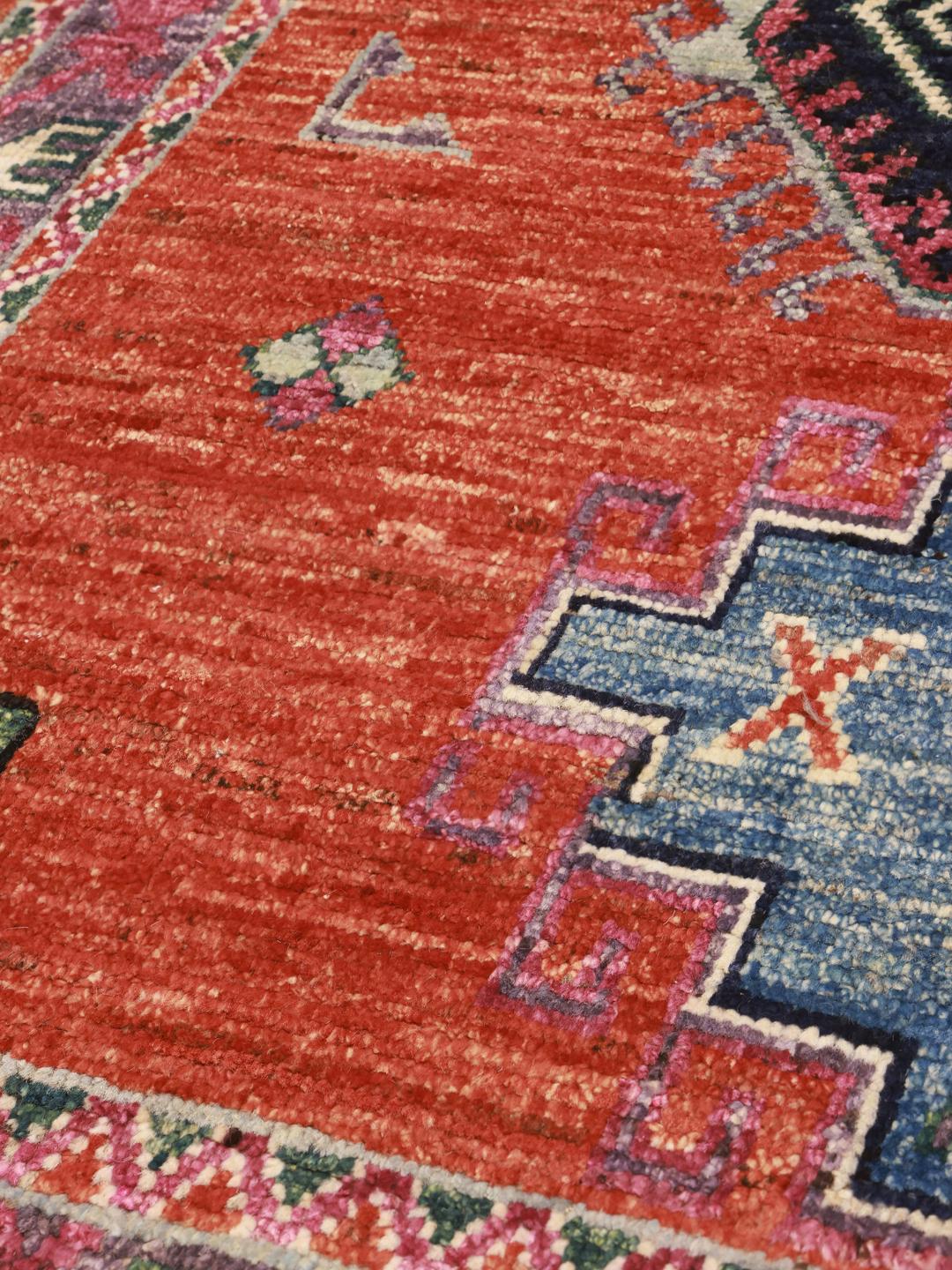 Hand-knotted Kazak rug from Afghanistan in vibrant red and blue tones