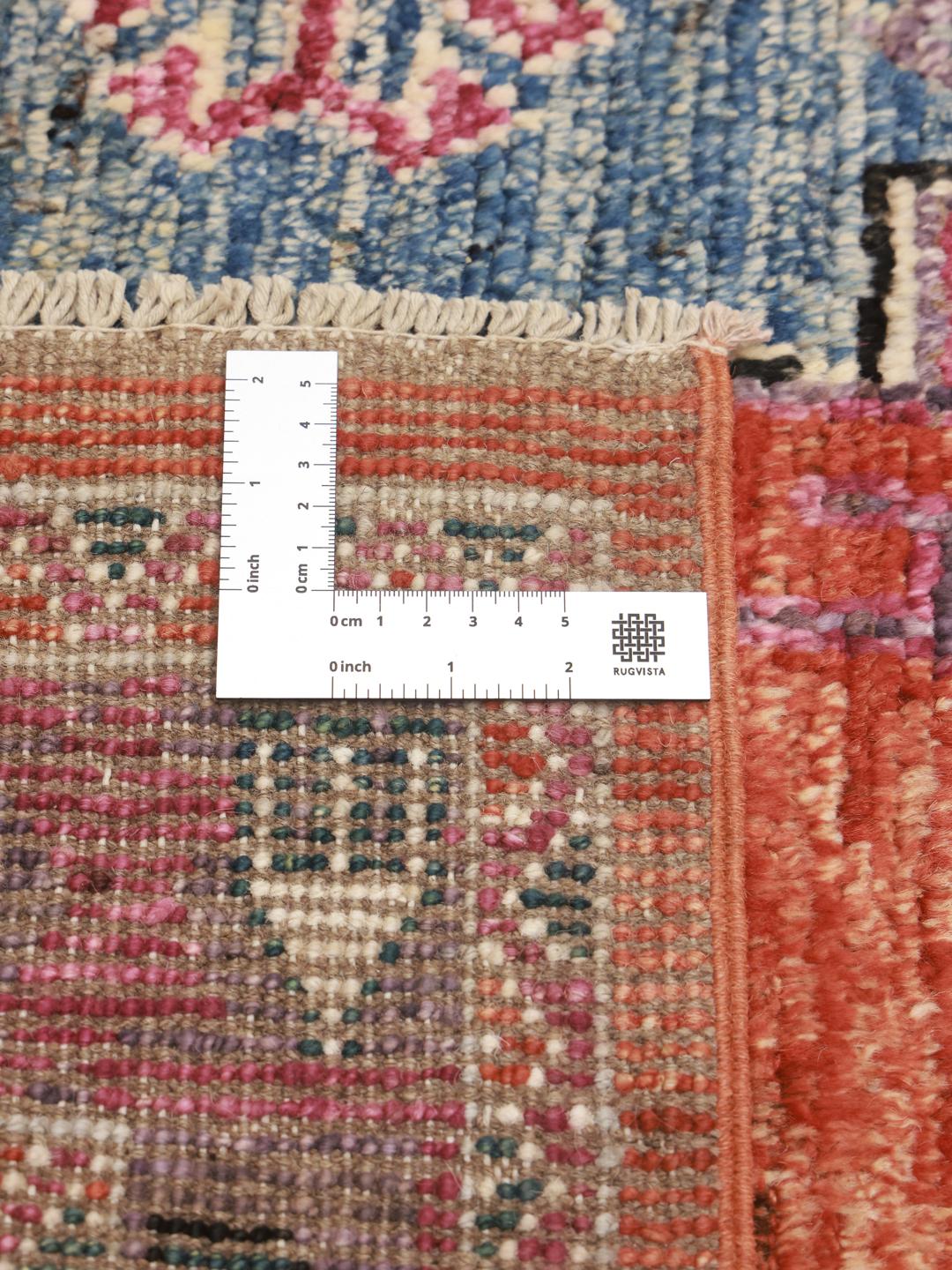 Hand-knotted Kazak rug from Afghanistan in vibrant red and blue tones