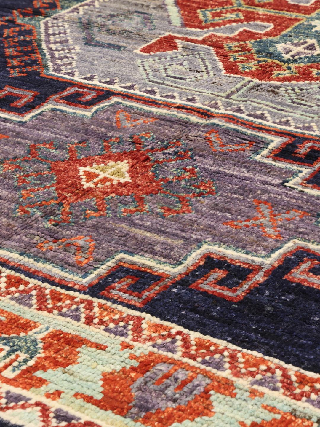 Hand-knotted Kazak rug from Afghanistan in dark blue and red tones