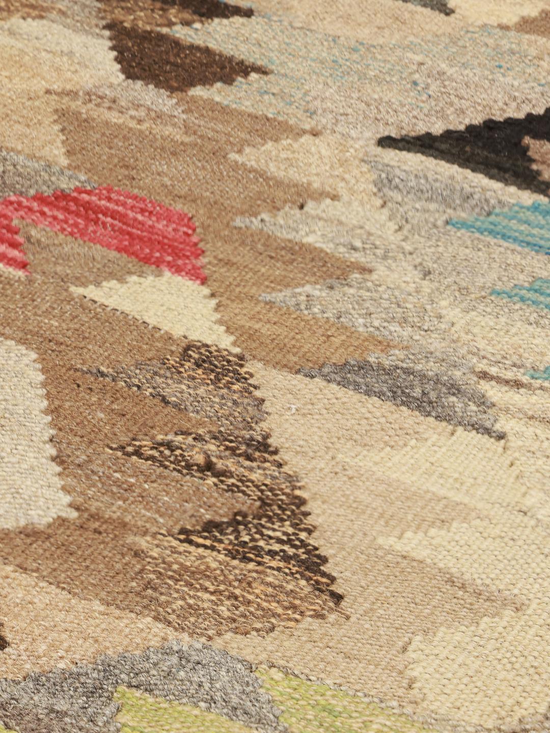 Hand-woven Afghan runner with geometric patterns in beige, red, and blue tones