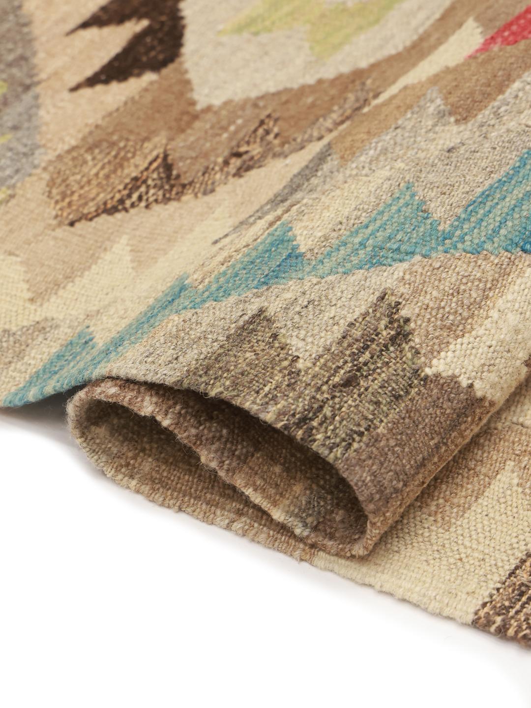 Hand-woven Afghan runner with geometric patterns in beige, red, and blue tones