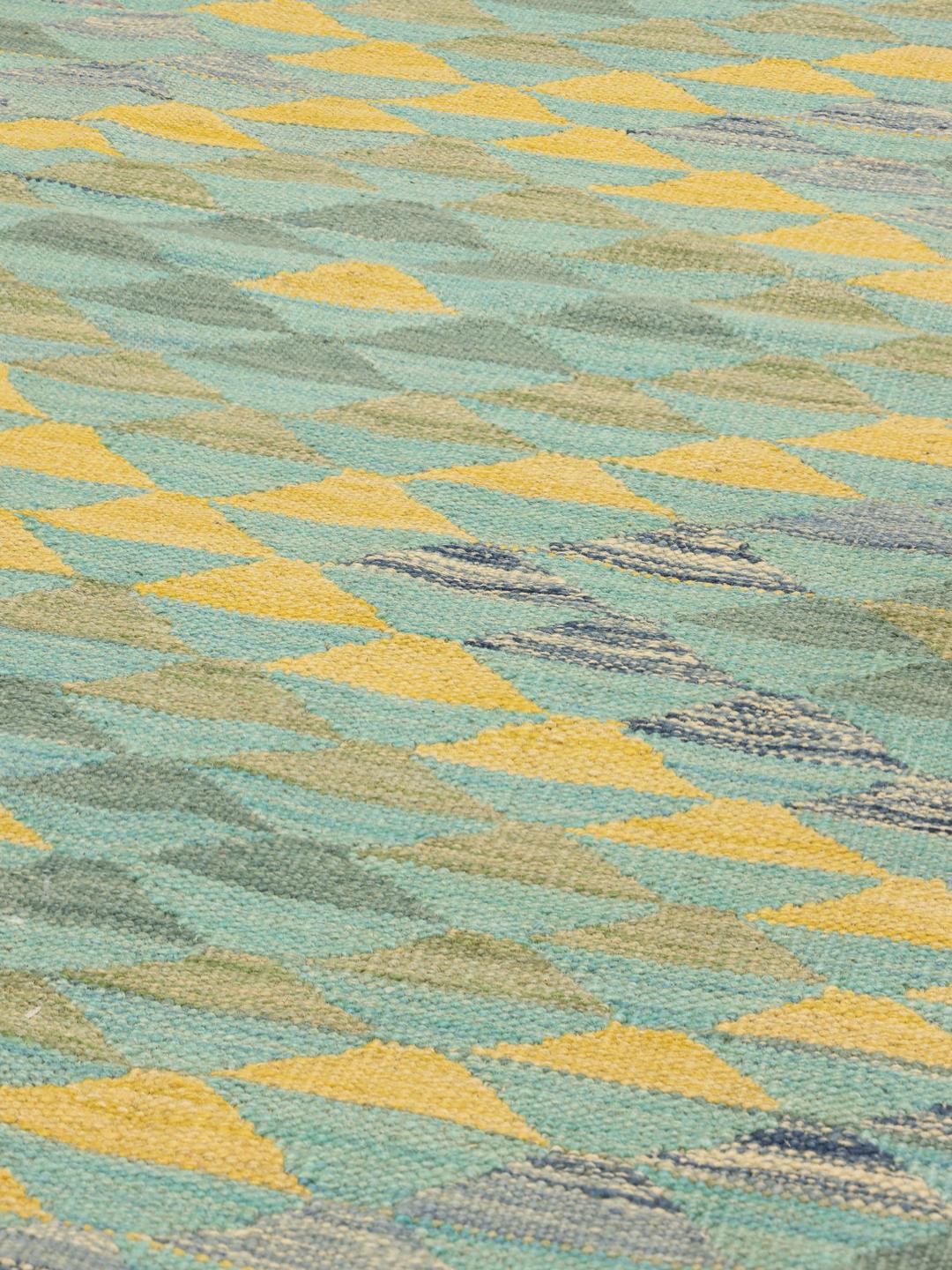 Handmade runner rug from Afghanistan with teal and yellow geometric patterns