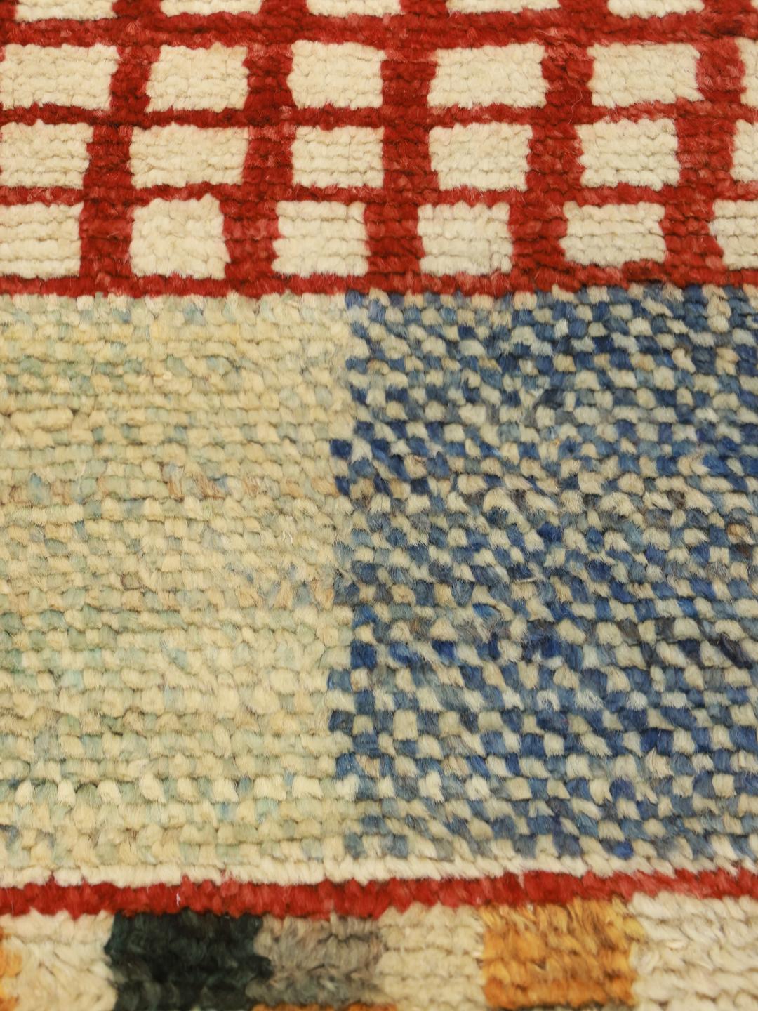 Hand-knotted Afghan rug with vibrant geometric patterns in a multicolor palette