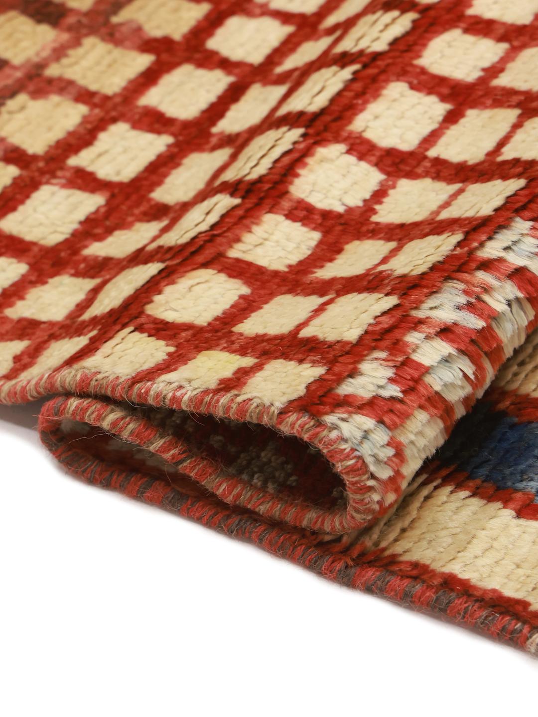 Hand-knotted Afghan rug with vibrant geometric patterns in a multicolor palette