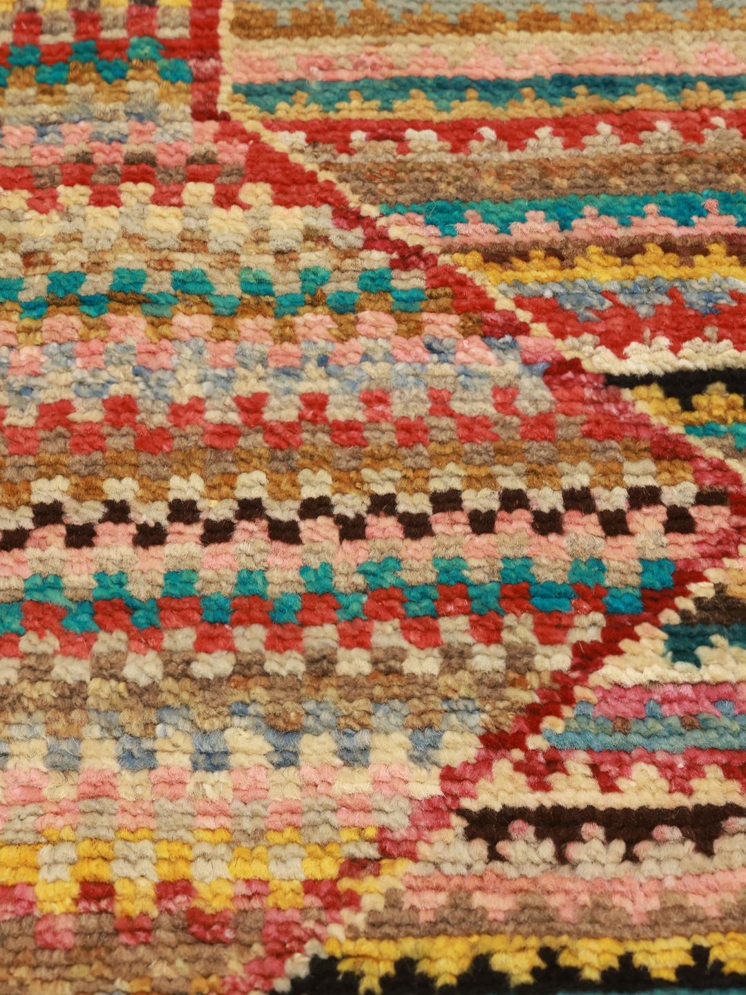 Hand-knotted multicoloured Berber rug from Afghanistan with a bold geometric medallion design.