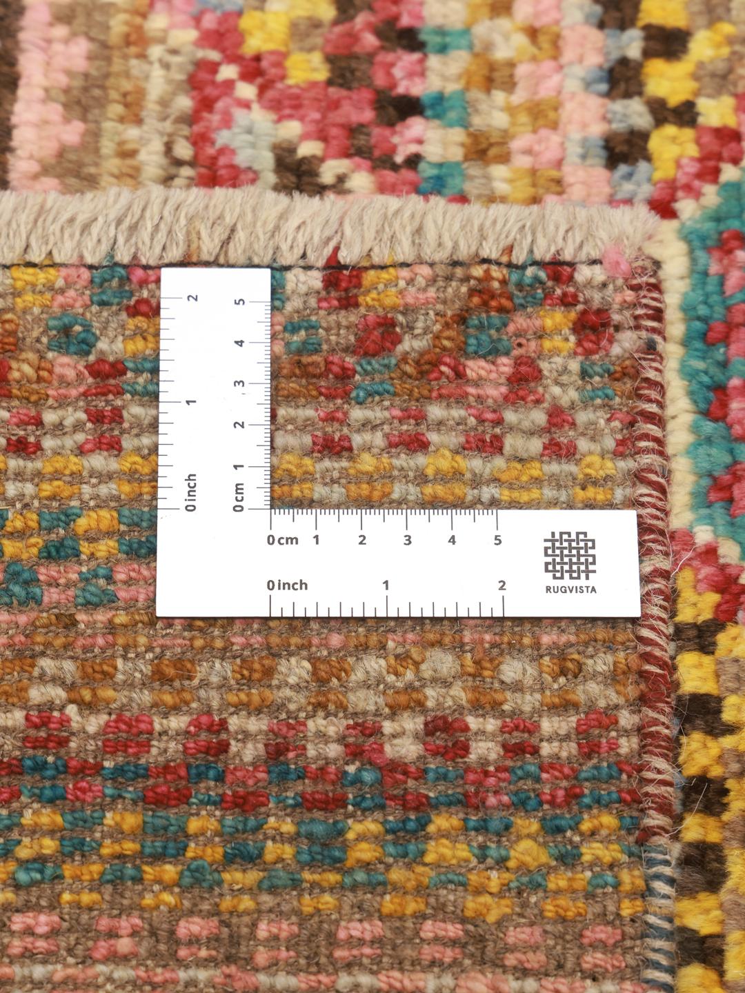 Hand-knotted multicoloured Berber rug from Afghanistan with a bold geometric medallion design.