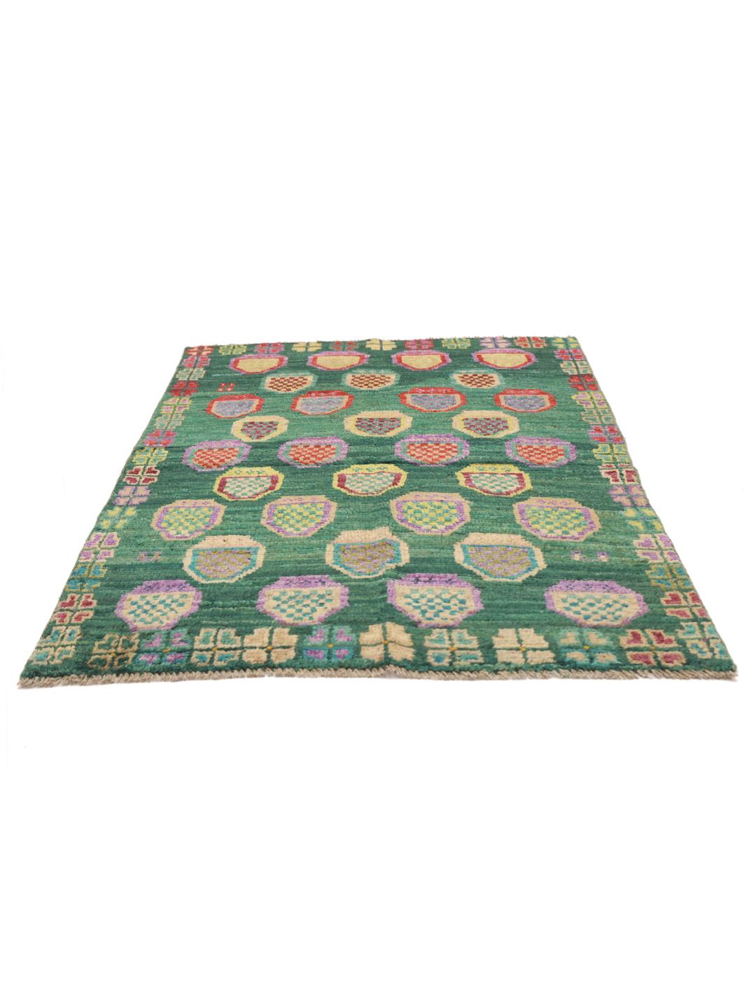 Hand-knotted Afghan rug with a vibrant green field and colourful geometric motifs.