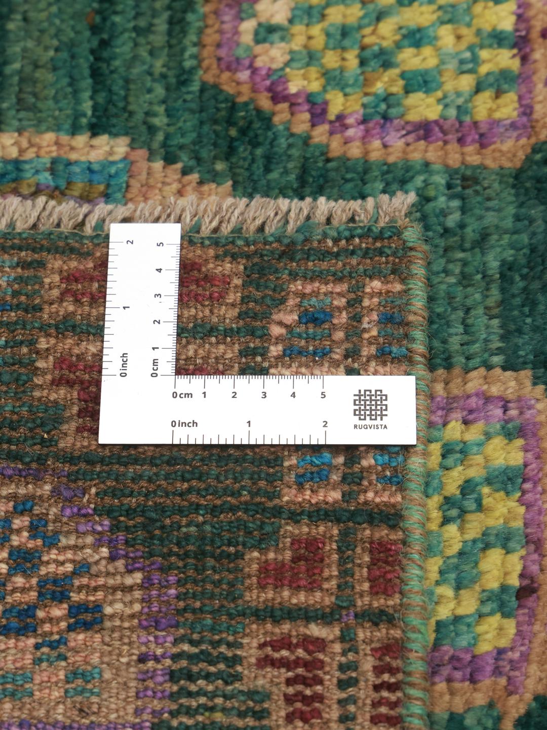 Hand-knotted Afghan rug with a vibrant green field and colourful geometric motifs.