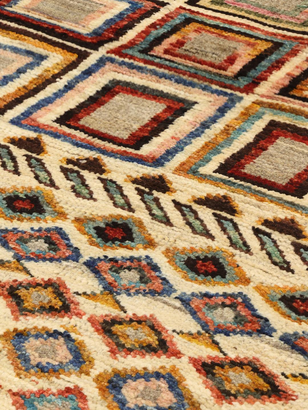 Handmade Afghan rug with beige background and colourful geometric patterns