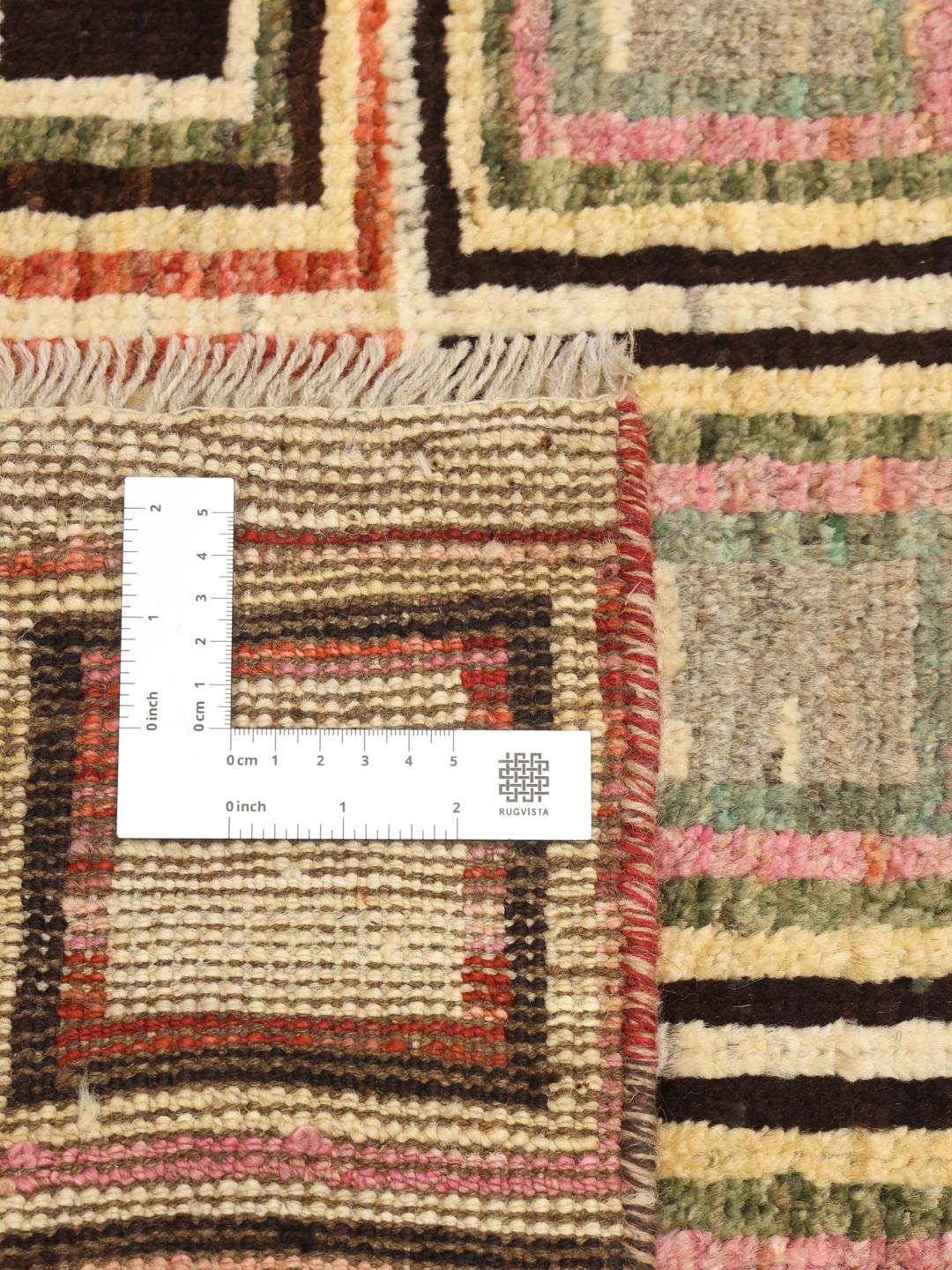 Handmade Afghan rug with beige background and colourful geometric patterns