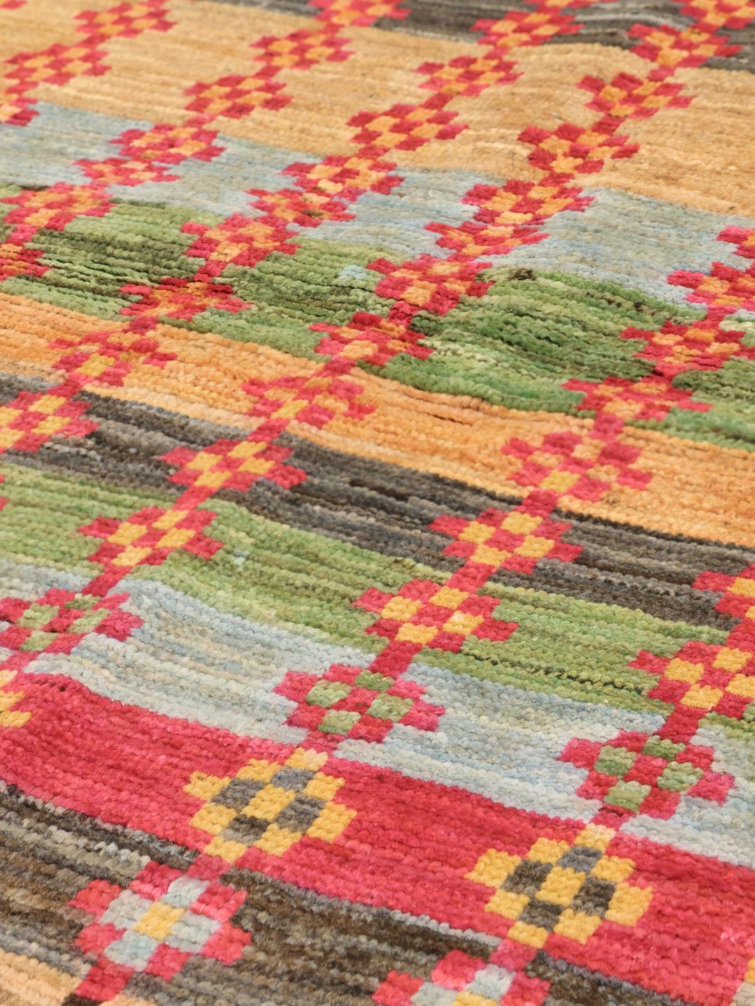 Handmade Afghan rug with multicolored stripes and geometric motifs