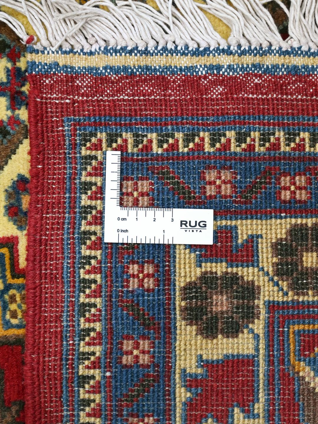 Håndknyttet afghansk tæppe i røde og beige nuancer