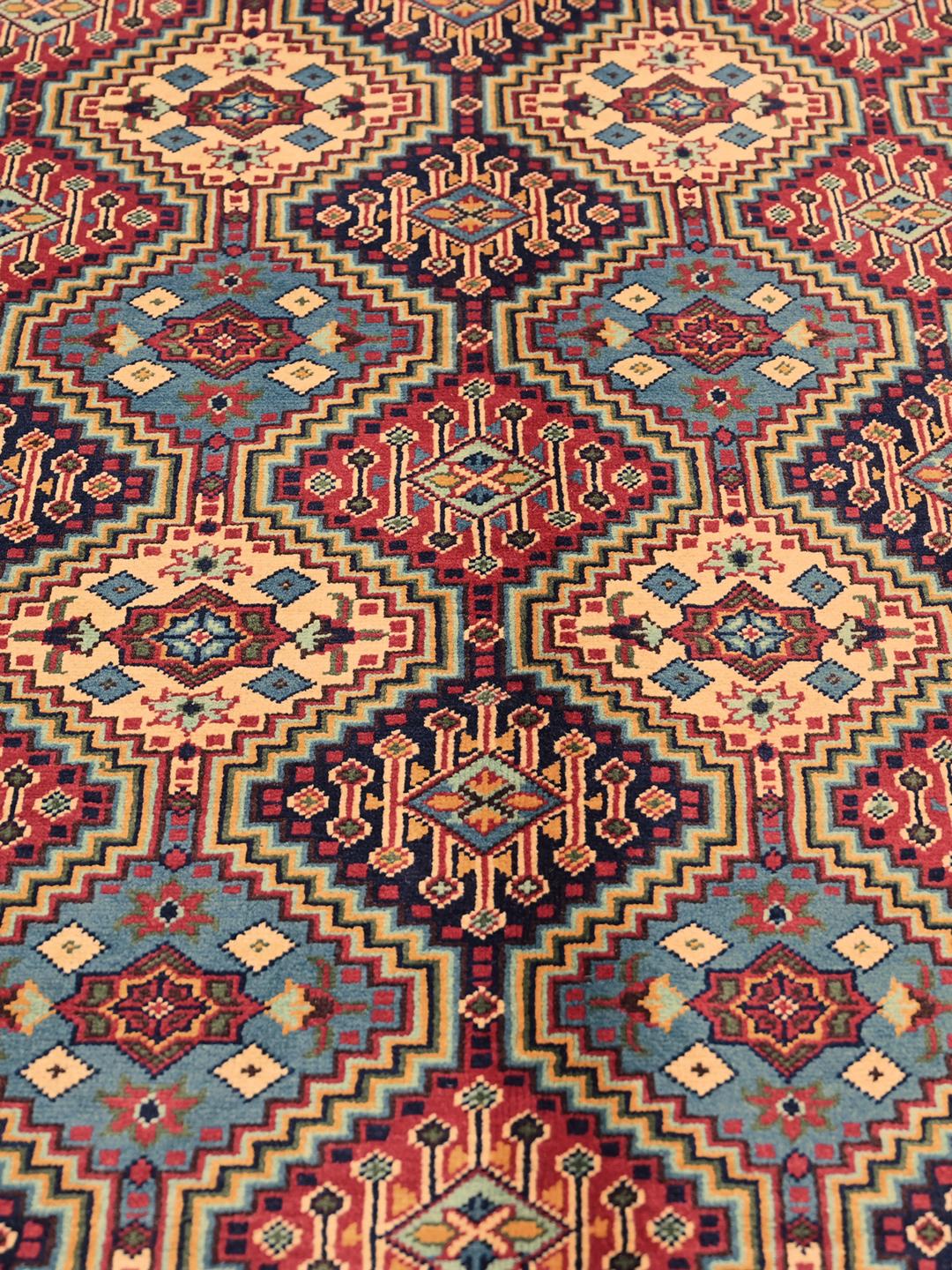 Hand-knotted Afghan Kunduz rug with red and blue geometric patterns