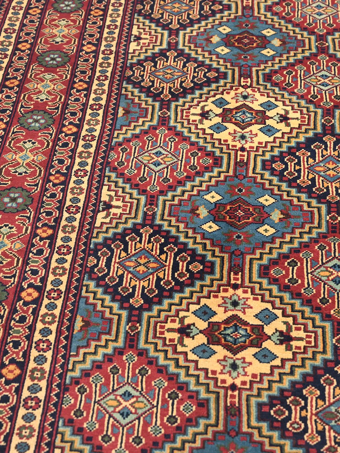 Hand-knotted Afghan Kunduz rug with red and blue geometric patterns