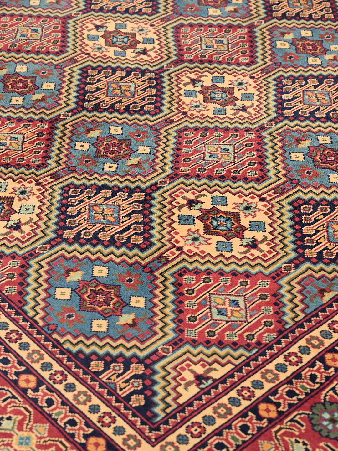 Hand-knotted Afghan Kunduz rug with red and blue geometric patterns