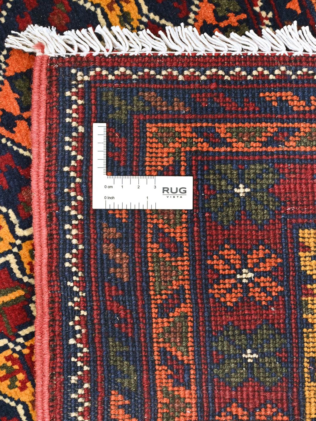 A large hand-knotted Kunduz rug from Afghanistan featuring a dark-red and multicolour geometric pattern.