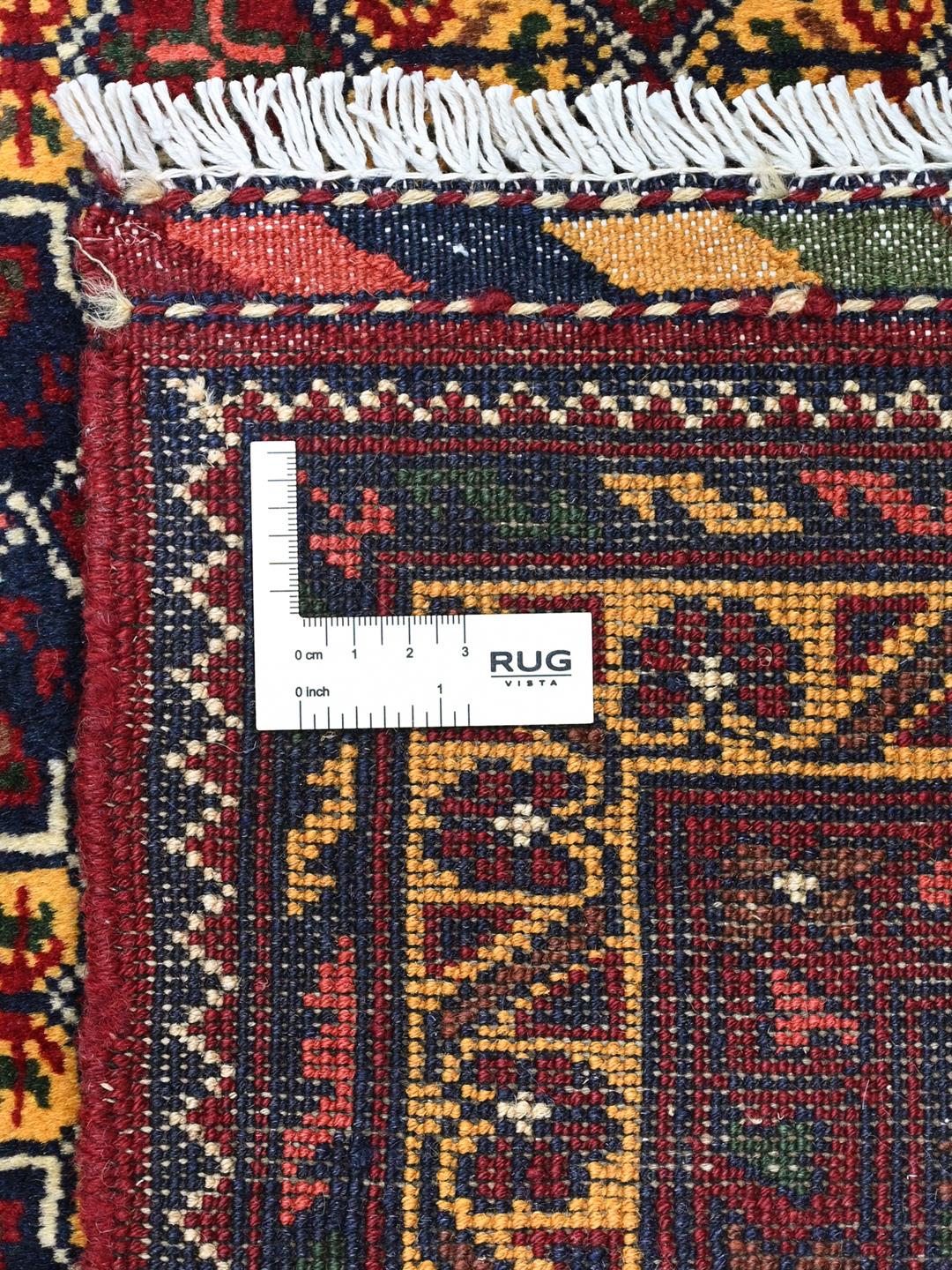 A hand-knotted Kunduz rug from Afghanistan with a dark-red and yellow geometric pattern.