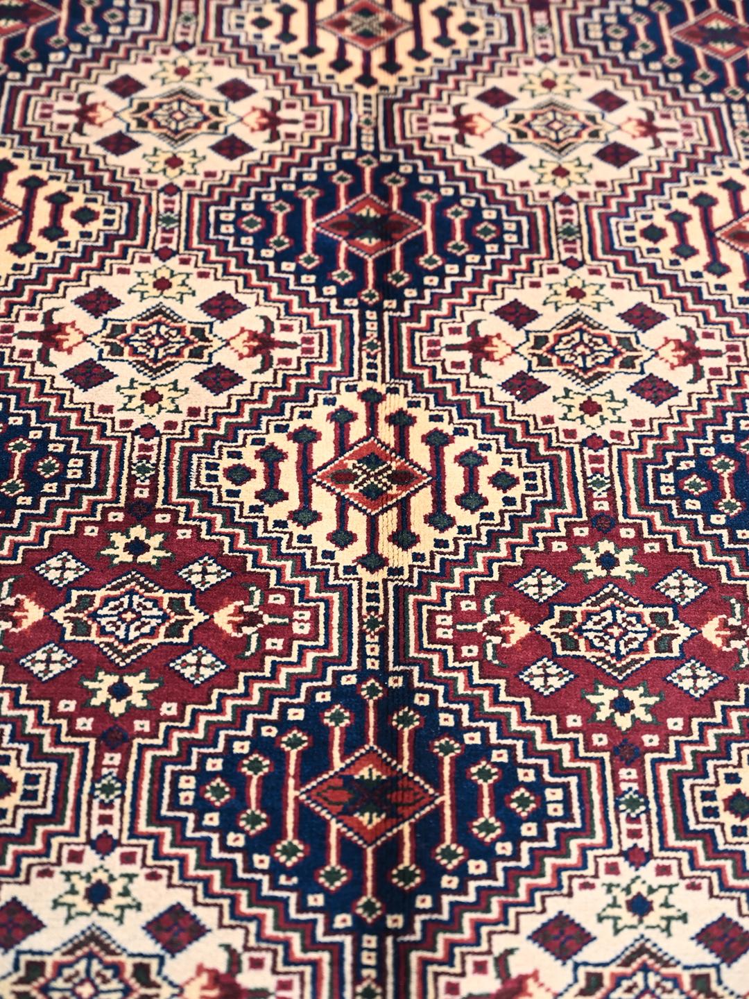 Hand-knotted Afghan Kunduz rug in deep red and blue tones
