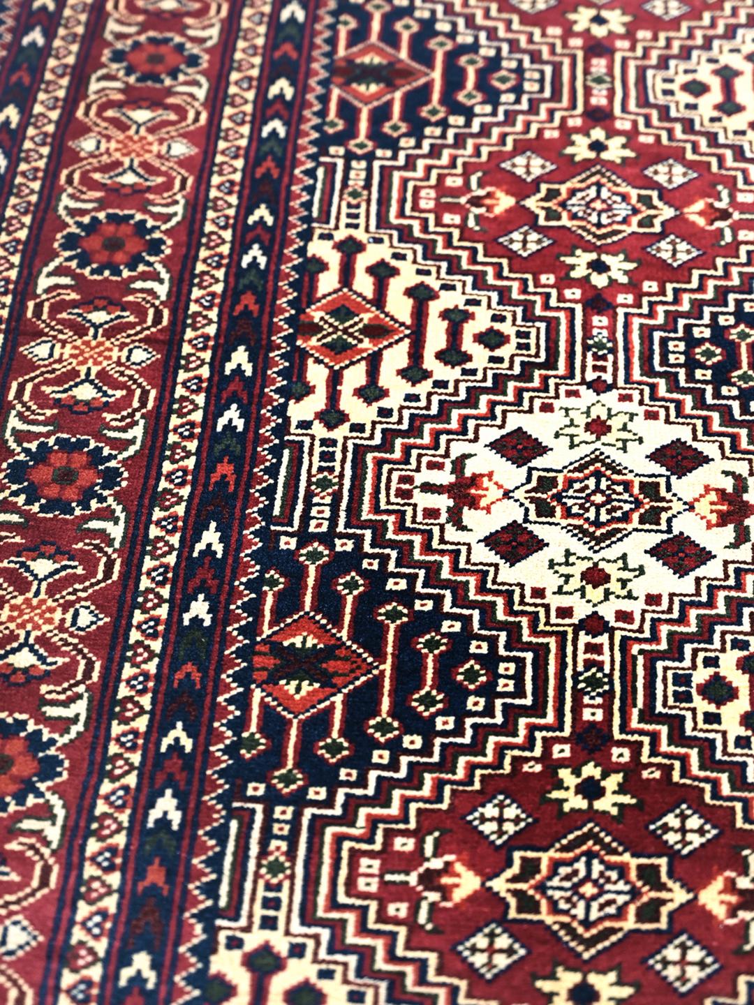 Hand-knotted Afghan Kunduz rug in deep red and blue tones