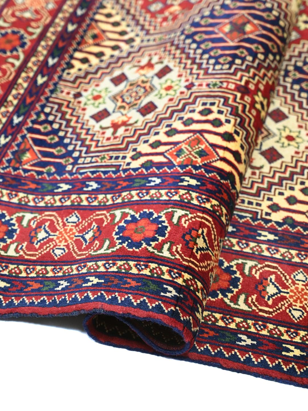 Hand-knotted Afghan Kunduz rug in deep red and blue tones