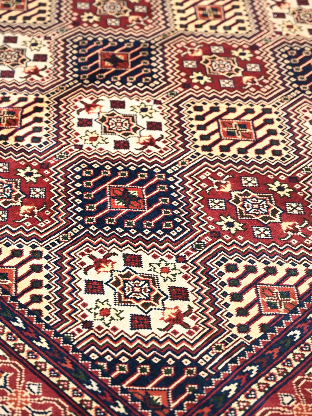 Hand-knotted Afghan Kunduz rug in deep red and blue tones
