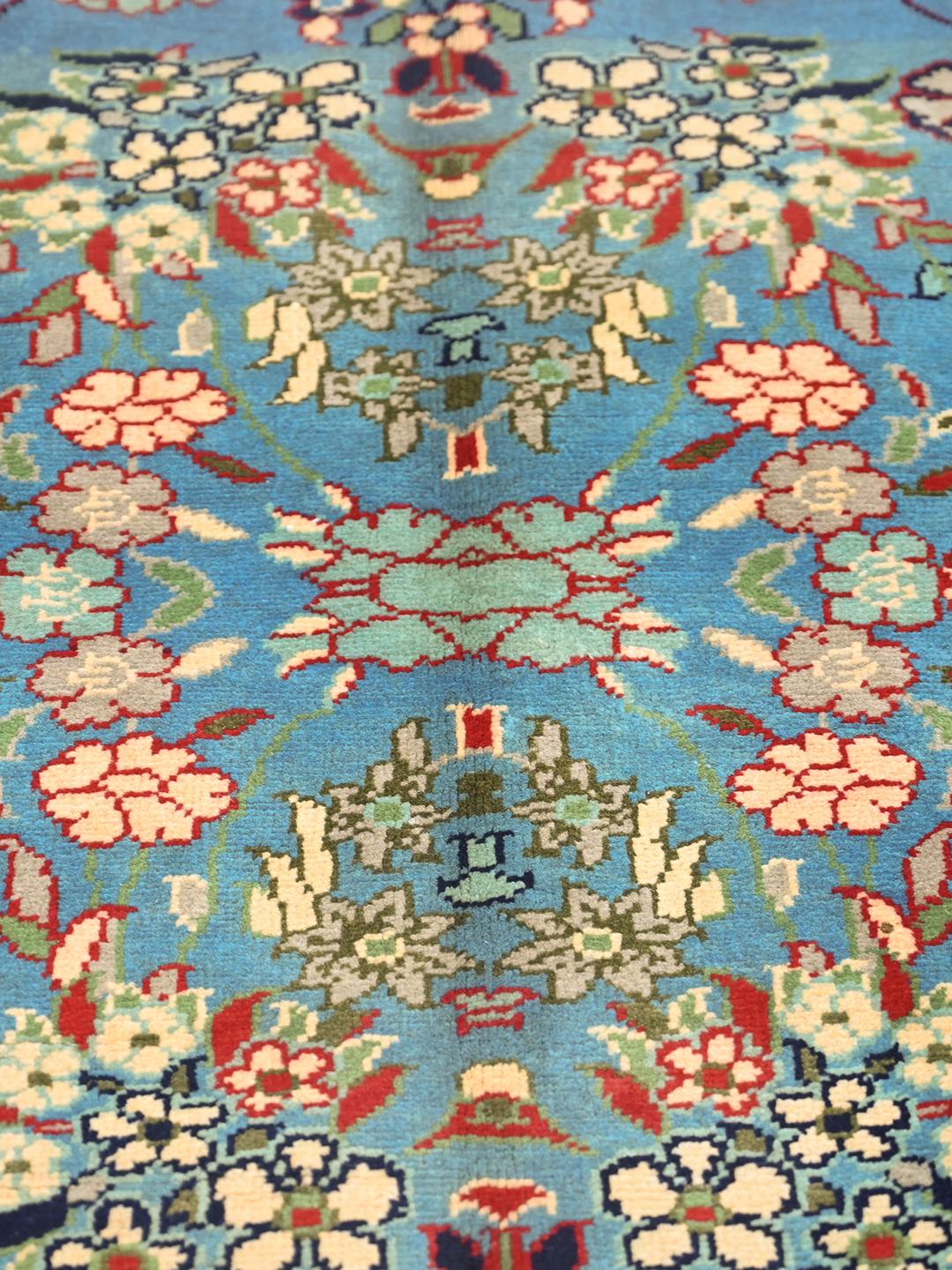 Een handgeknoopt Kunduz-tapijt uit Afghanistan met een blauw veld en bloemenpatroon