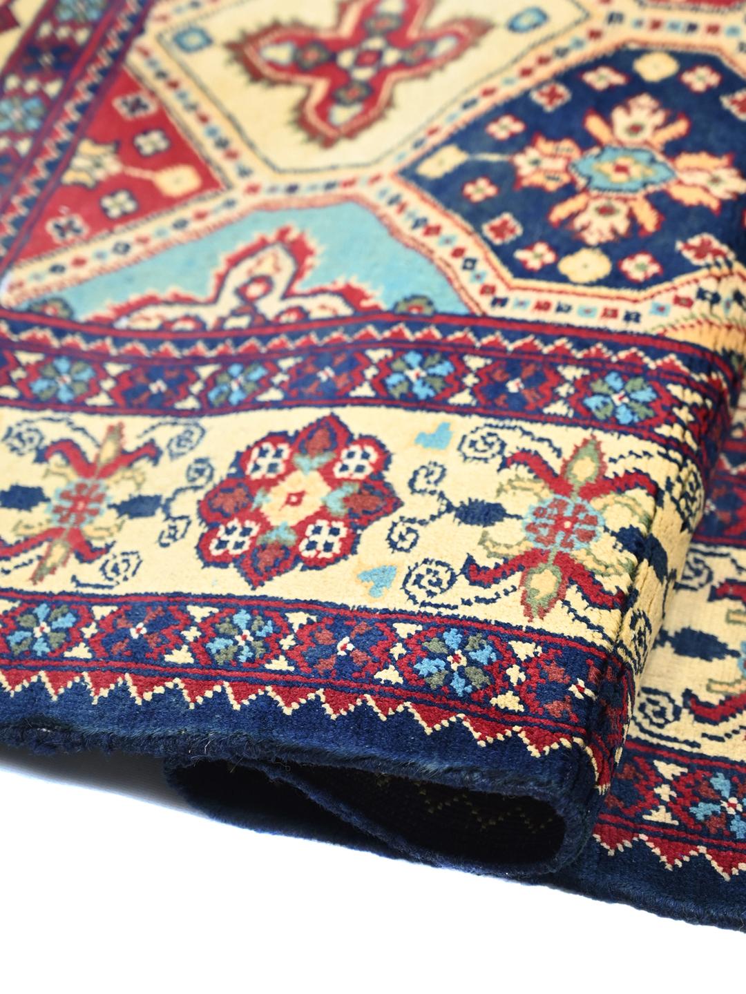 A hand-knotted Kunduz rug from the Middle East featuring a geometric diamond pattern in multicolor wool.