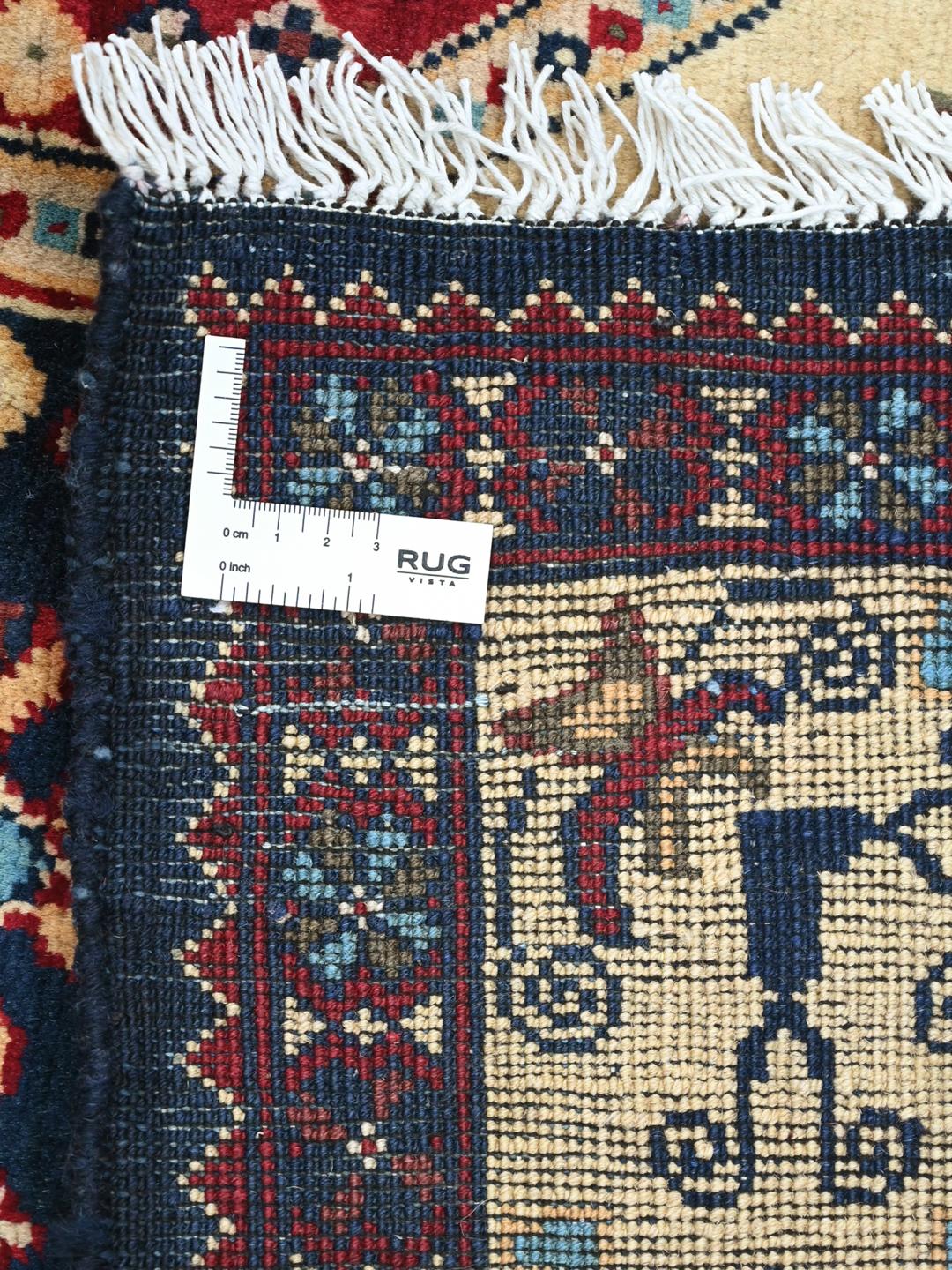 A hand-knotted Kunduz rug from the Middle East featuring a geometric diamond pattern in multicolor wool.