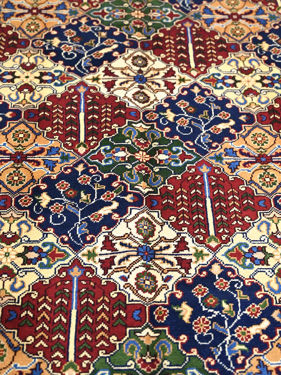 Hand-knotted Middle Eastern Kunduz rug with multicolor geometric patterns.