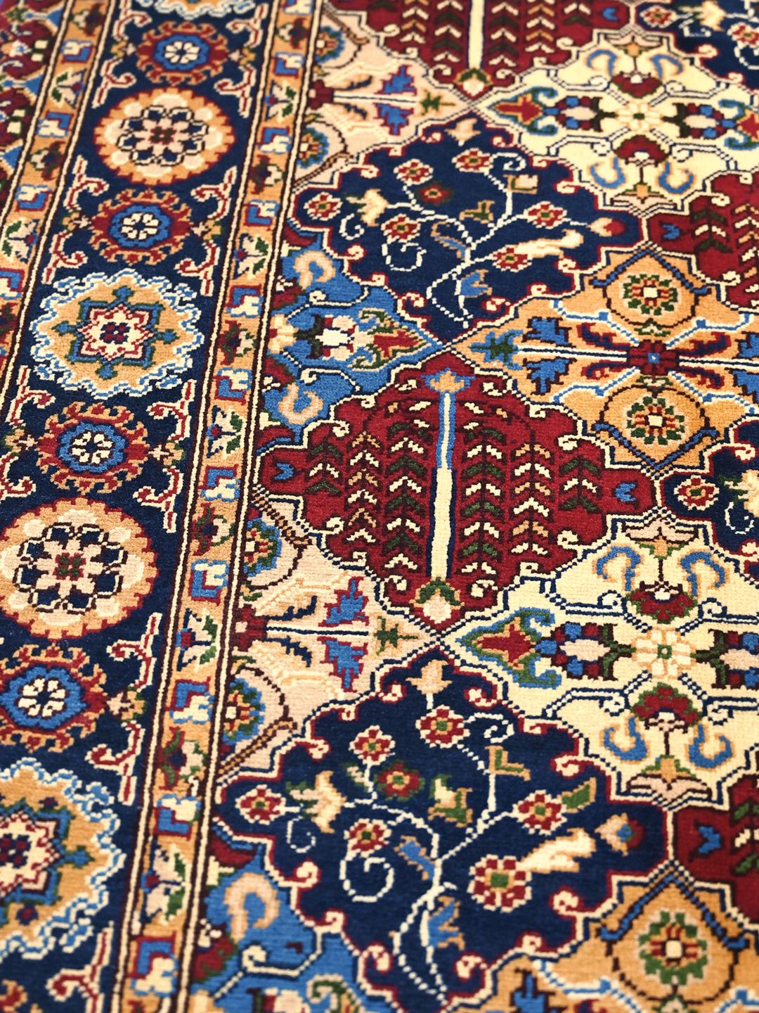 Hand-knotted Middle Eastern Kunduz rug with multicolor geometric patterns.