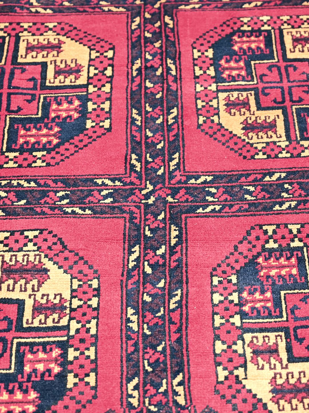 Hand-knotted Middle Eastern Kunduz rug in deep red and black tones