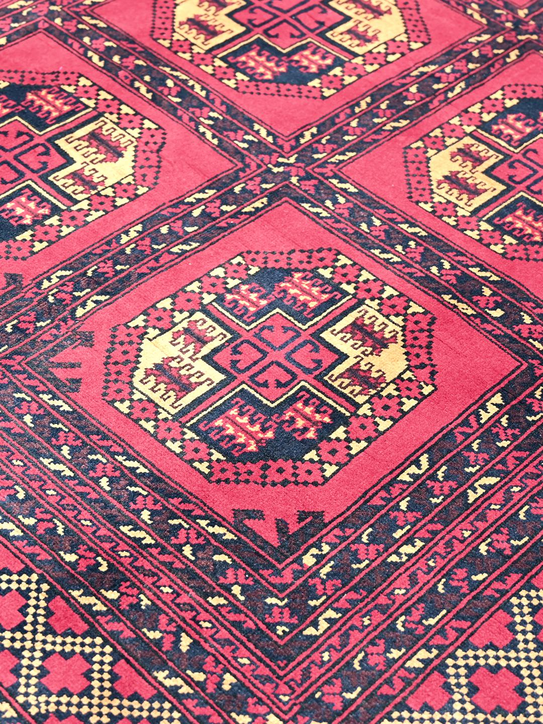 Hand-knotted Middle Eastern Kunduz rug in deep red and black tones