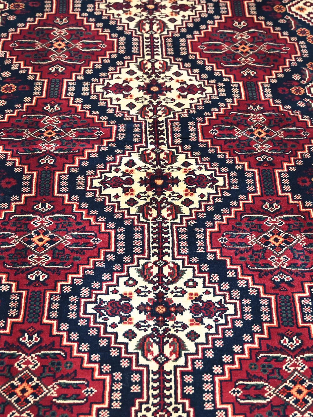 Handmade Afghan Kunduz rug in red and dark blue