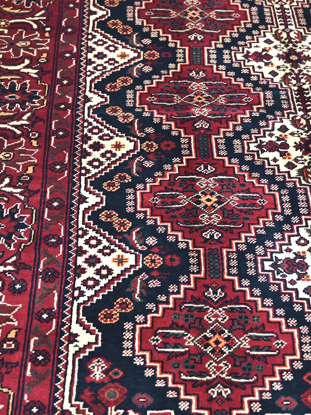 Handmade Afghan Kunduz rug in red and dark blue