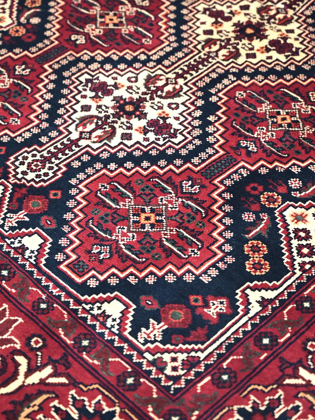 Handmade Afghan Kunduz rug in red and dark blue