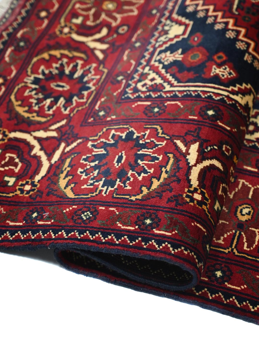 Handmade Afghan Kunduz rug in red and dark blue