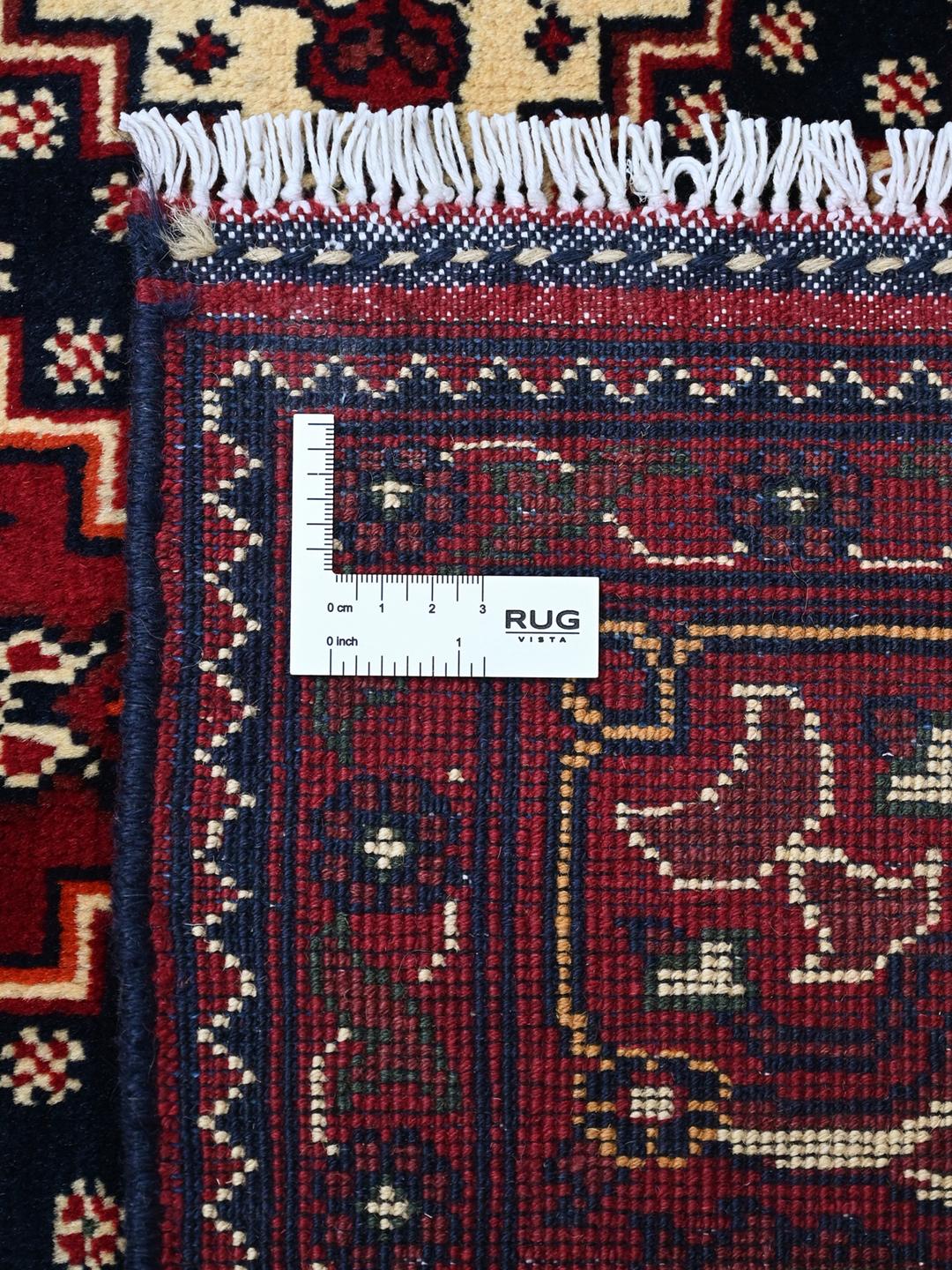 Handmade Afghan Kunduz rug in red and dark blue
